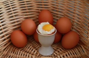 Eggs in a basket and a cooked egg in an egg dish