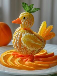 orange sections and peel make a baby chicken style fruit art