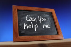 How can caregivers ask for help? black chalkboard with brown wooden frame written on it -can you help me?